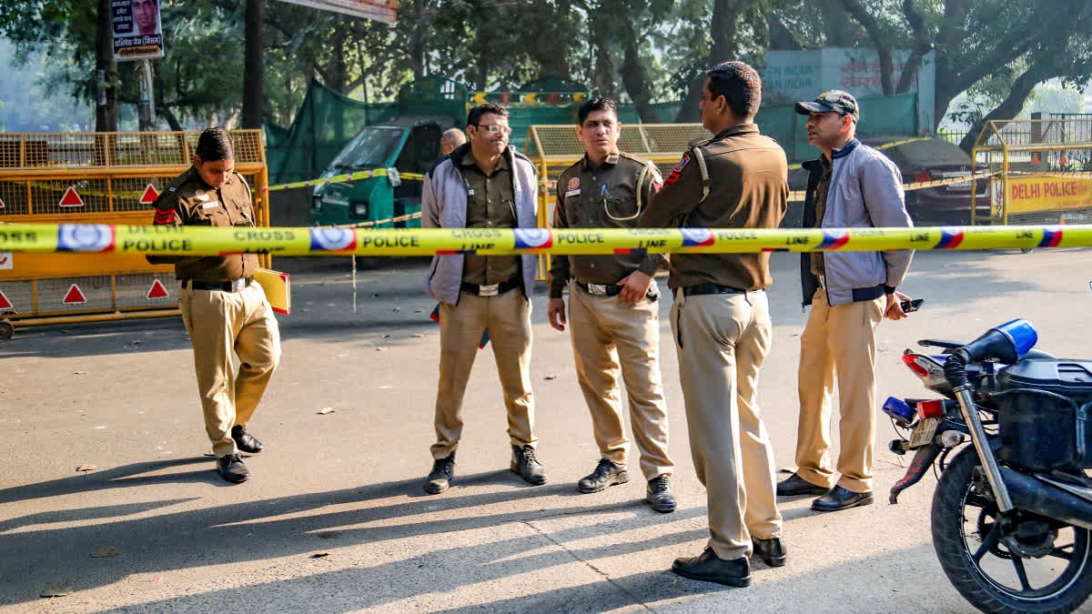 Police personnel stand guard near a cordoned area where a low-intensity blast occurred on Thursday near a cinema hall at Rohini area, in New Delhi, Friday, Nov. 29, 2024.