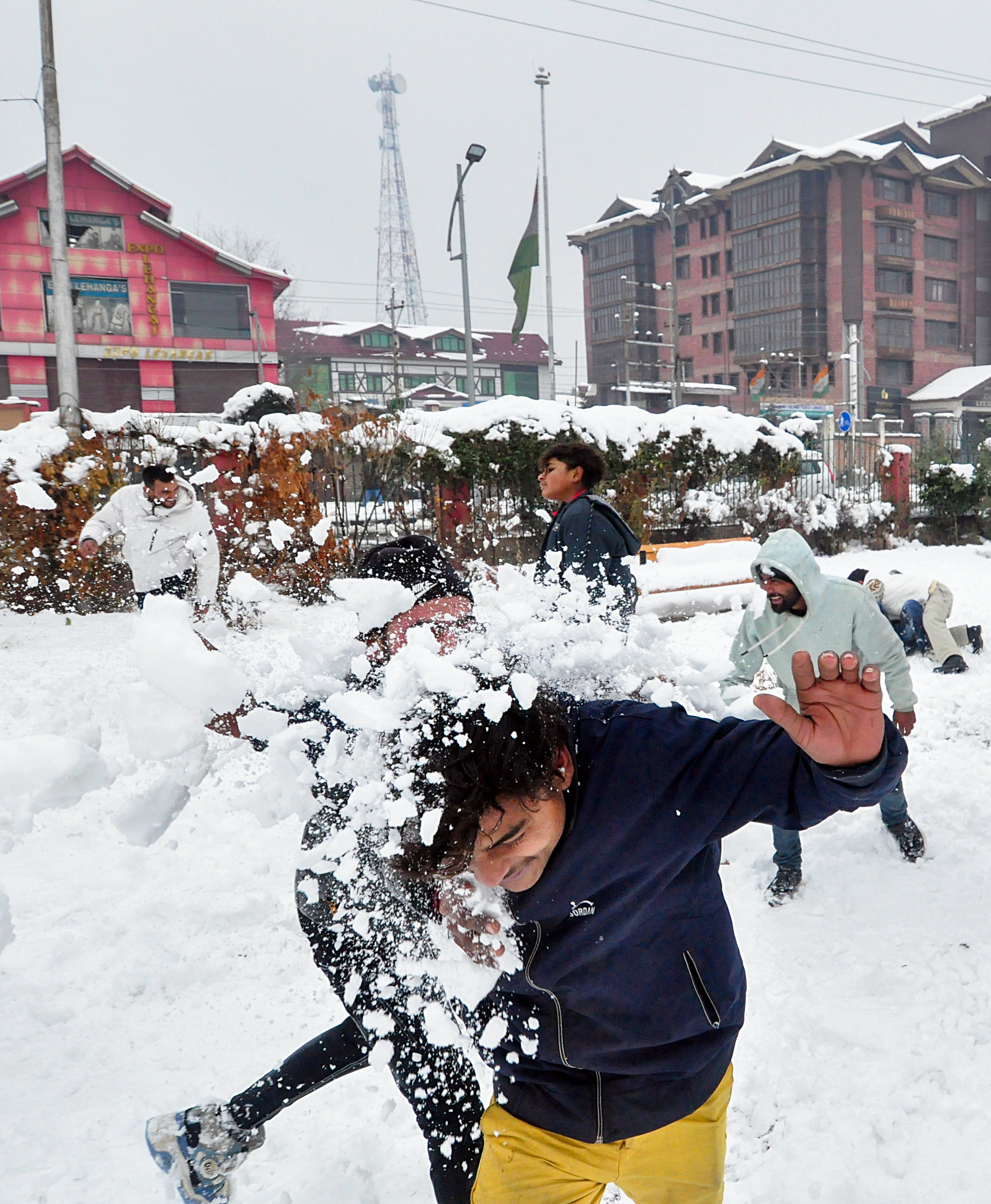 Tourists enjoy throwing snowballs after heavy snowfall in Kashmir Valley, in Srinagar on Saturday.