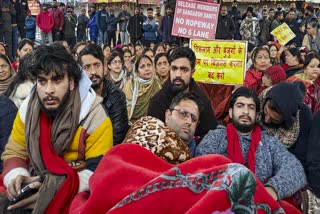 Shopkeepers sit on a hunger strike during a protest called by Shri Mata Vaishno Devi Sangharsh Samiti, at Katra, in Reasi district, Jammu and Kashmir, Saturday, Dec. 28, 2024. The shutdown against a proposed ropeway project in the Trikuta hills of Reasi district entered its fifth day on Sunday