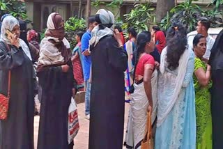 Women queuing in front of post office