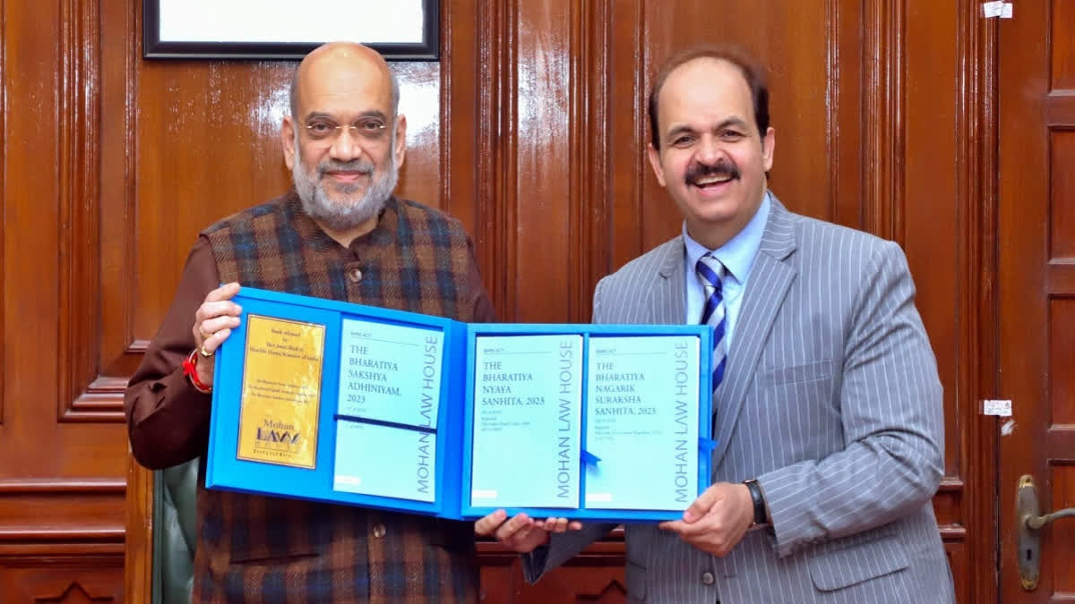 Home Minister Amit Shah releasing reference books on new criminal laws on Dec 30, 2023. (Right) Dr Vinay Ahuja, Managing Director of Mohan Law House.