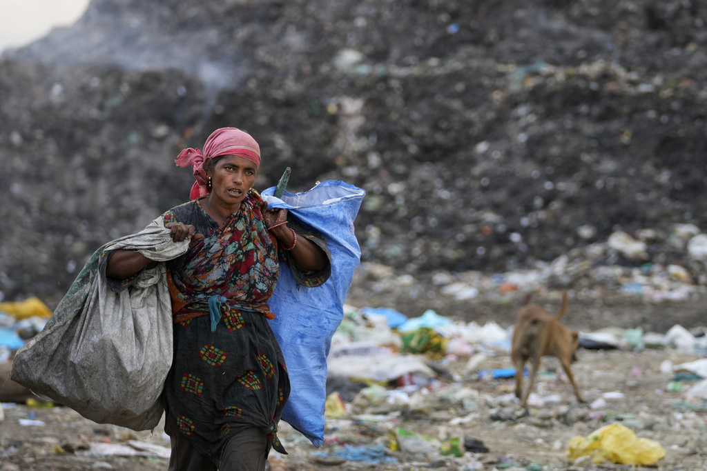 Waste picker Salmaa Shekh collects recyclables during a heat wave at a garbage dump