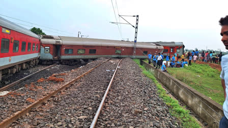 People gather near the Howrah-Mumbai Express train that derailed near Jamshedpur in Jharkhand on July 30, 2024.