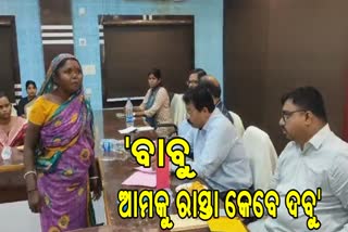 woman questions officials about village issue