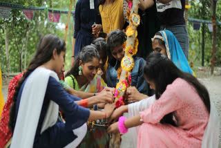 women and daughters tie rakhi in tree in Udaipur