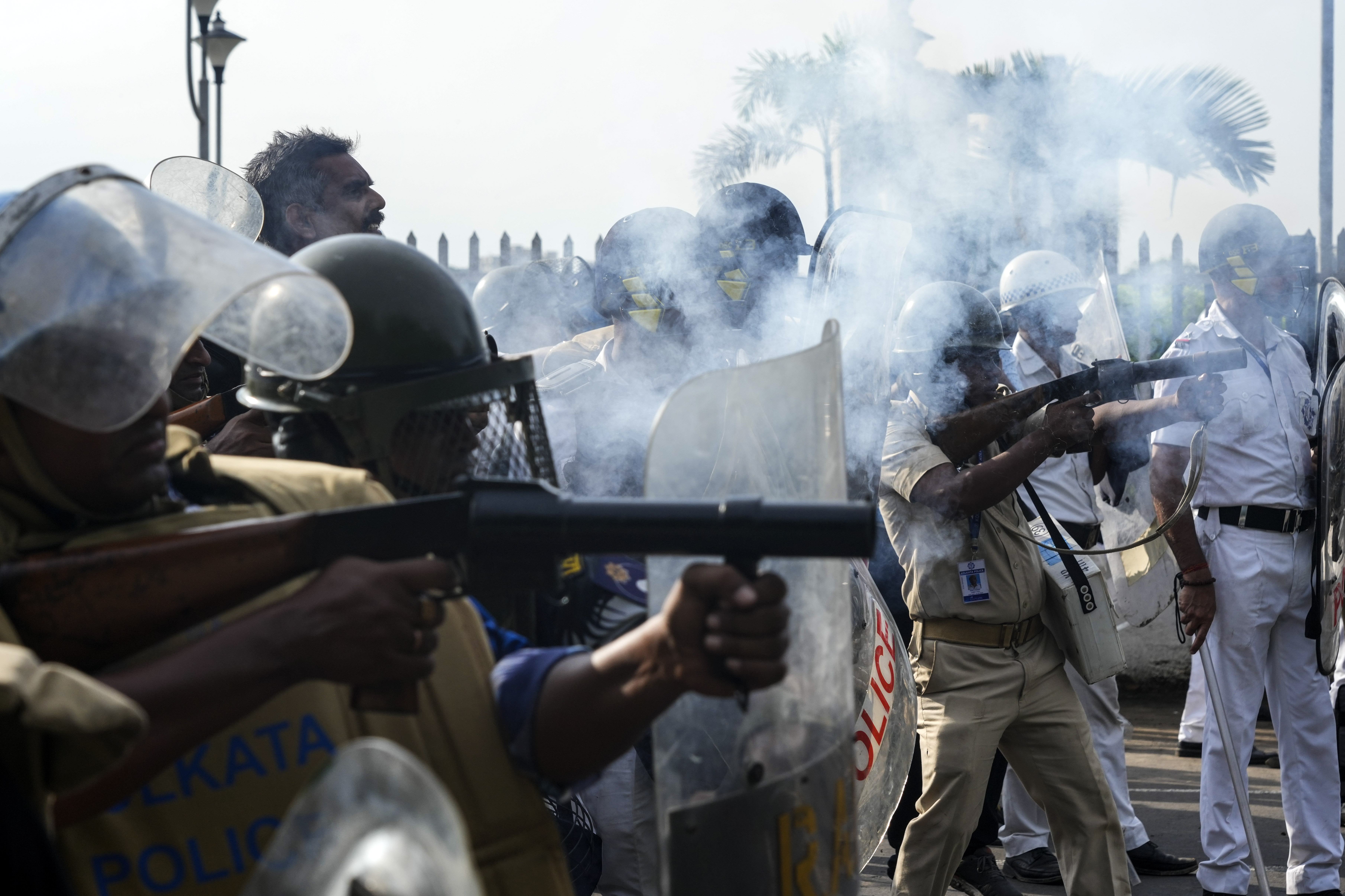 A policeman hits a protester, protesting against the rape and murder of a resident doctor at a government hospital earlier this month, in Kolkata