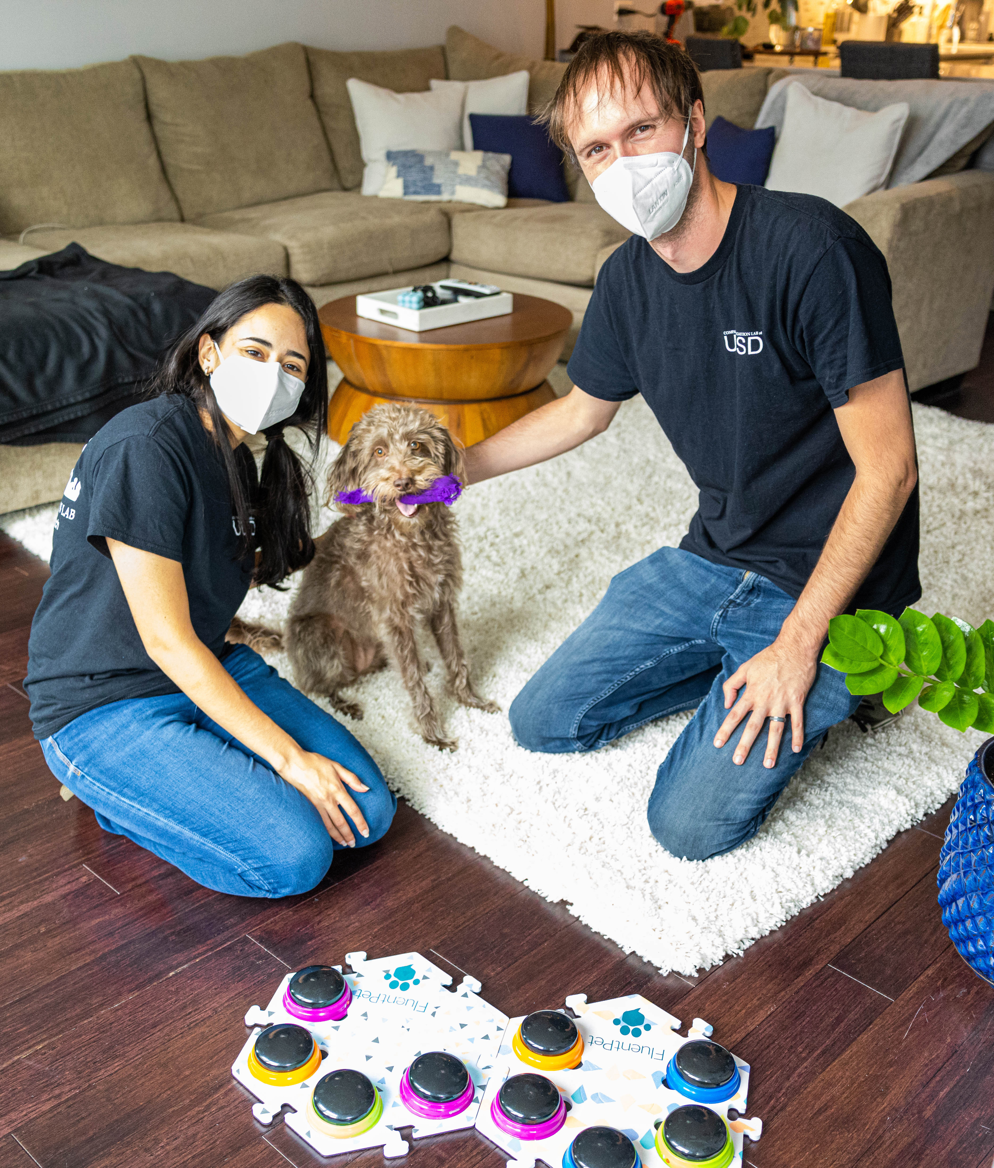 Researchers Amalia Bastos and Patrick Wood with one of the canine study subjects in the dog's home