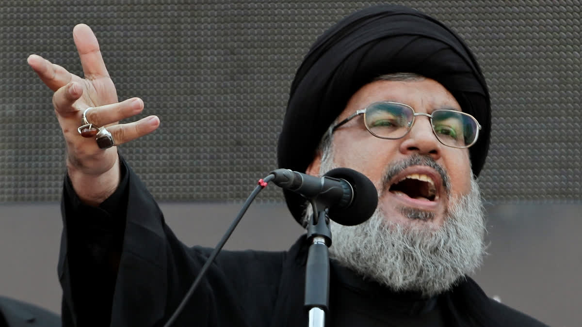 FILE - Hezbollah leader Sheik Hassan Nasrallah, speaks to the crowd in a rare public appearance during Ashura, that marks the death of Shiite Islam's Imam Hussein, in the suburbs of Beirut, Nov. 14, 2013.