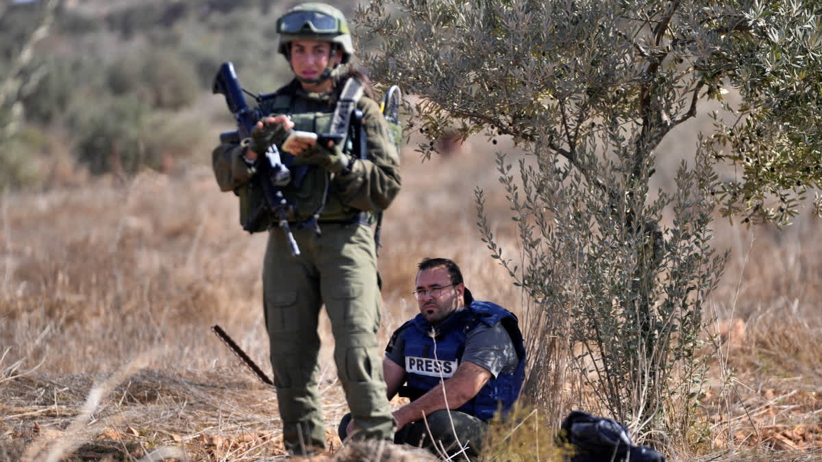 Israeli army troops temporarly detain Palestinian journalist Hesham Abu Shaqra, who was later released, while foreign activists and three European politicians joined the villagers on occasion of the Palestinian olive harvest season, and denied farmers access to their land in the West Bank town of Qusra, south of Nablus Tuesday, Oct. 29, 2024.