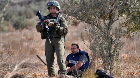 Israeli army troops temporarly detain Palestinian journalist Hesham Abu Shaqra, who was later released, while foreign activists and three European politicians joined the villagers on occasion of the Palestinian olive harvest season, and denied farmers access to their land in the West Bank town of Qusra, south of Nablus Tuesday, Oct. 29, 2024.