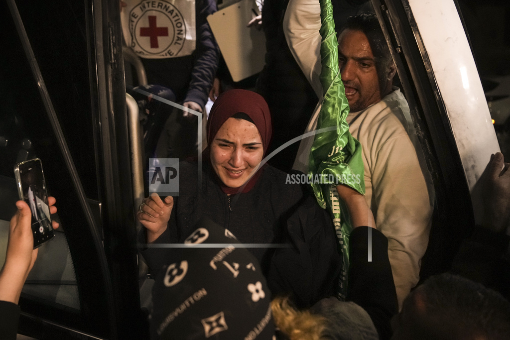 A woman smiles as she is welcomed after being released from prison by Israel