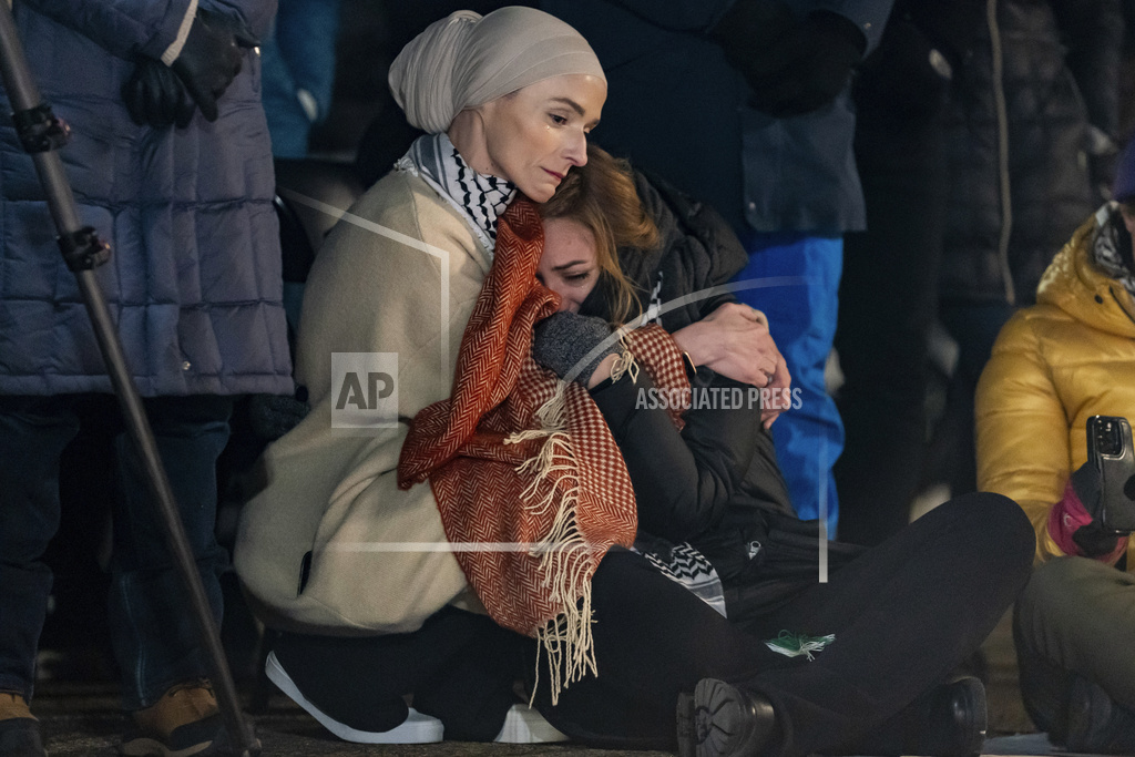 Activist Sumaya Awad with the Adalah Justice Project cries while listening to speakers during a vigil outside the White House