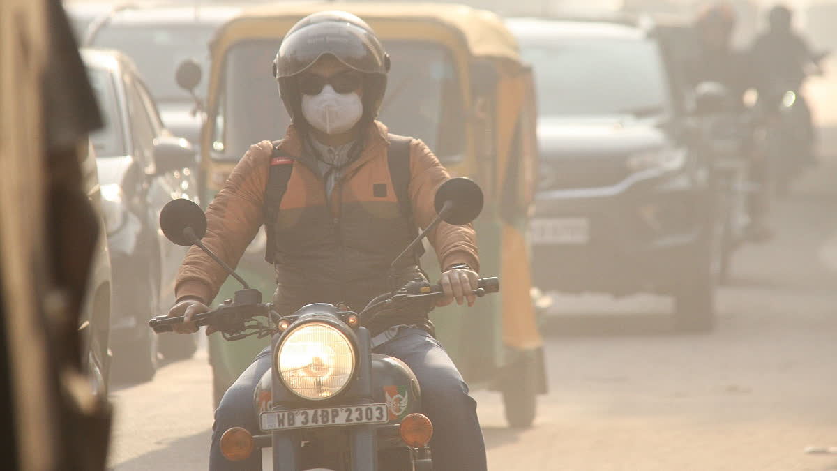 Commuter wears face mask as air quality deteriorates due to smog, in Gurugram on Friday.