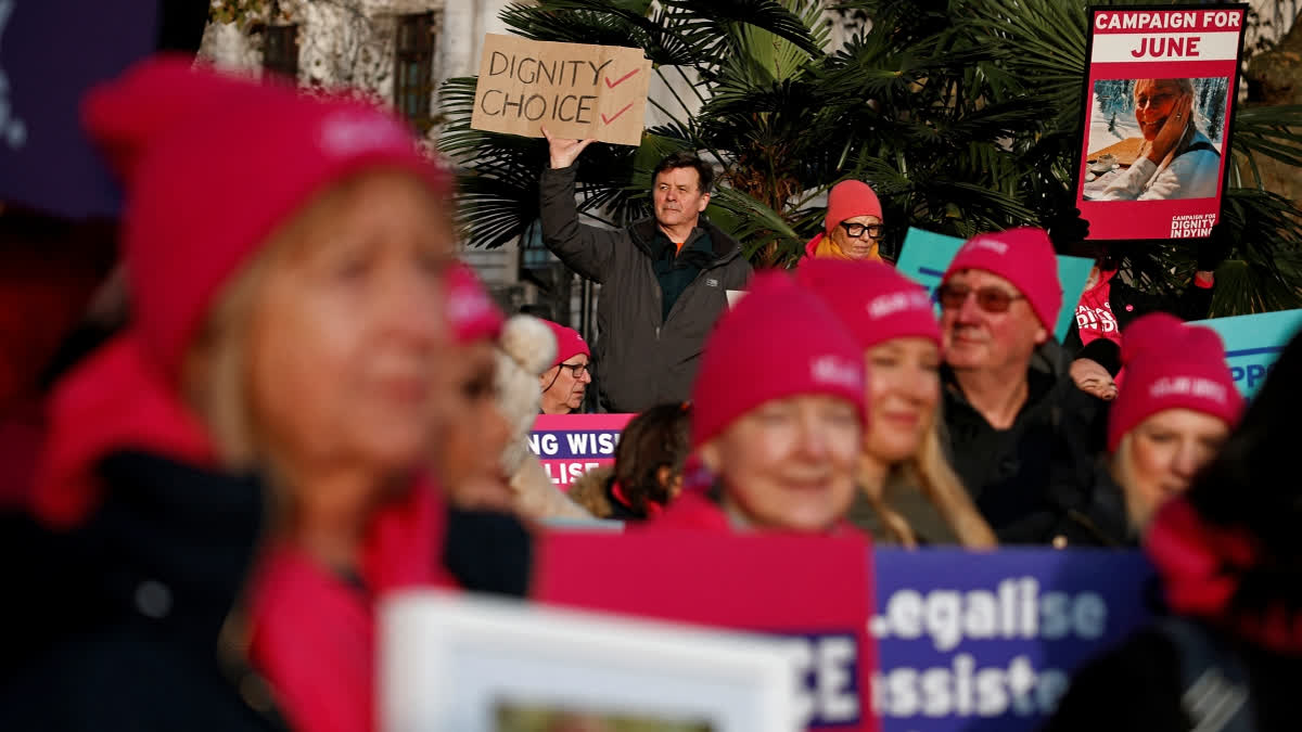 Campaigners supporting the assisted suicide bill hold placards at a demonstration outside The Palace of Westminster in central London, on November 29, 2024, as supporters and opponents of a bill to legalise euthanasia in the UK gather outside the Houses of Parliament while lawmakers debate the bill.