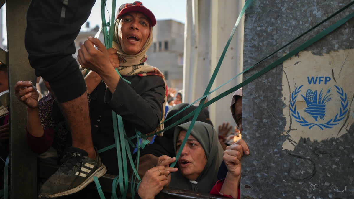 Two children and a 50-year-old woman were crushed to death Friday as a crowd of Palestinians pushed to get bread at a bakery in the central Gaza town of Deir al-Balah, medical officials said.