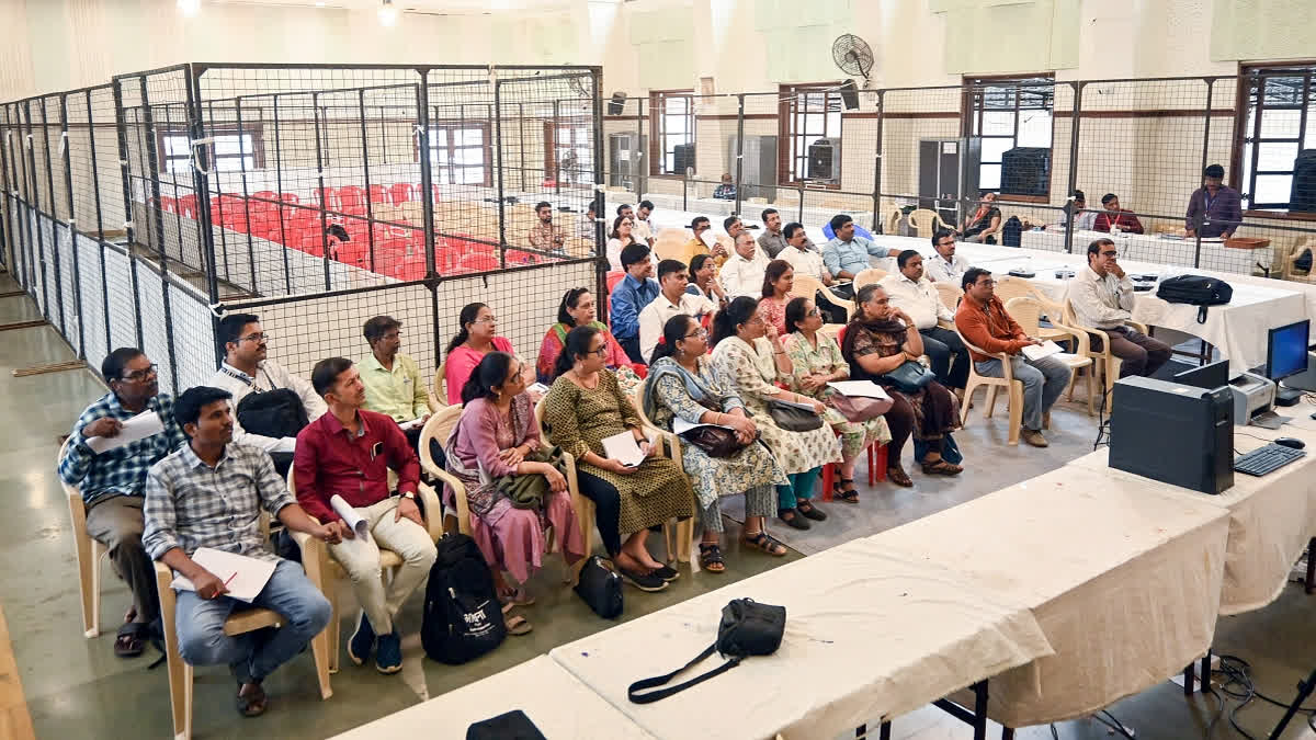 Election Commission staff receive instruction on the eve of vote counting of Maharashtra Assembly Elections, in Mumbai on Friday.