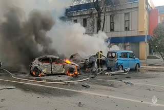 In this photo taken from video released by Russia Emergency Situations Ministry telegram channel on Saturday, Dec. 30, 2023, firefighters extinguish burning cars after shelling in Belgorod, Russia. Russian officials have accused Ukrainian forces of shelling the Russian border city of Belgorod. Two children were killed in Saturday's attack, regional governor Vyacheslav Gladkov said in a statement on social media. He also said that an unspecified number of people had been injured. (Russia Emergency Situations Ministry telegram channel via AP)