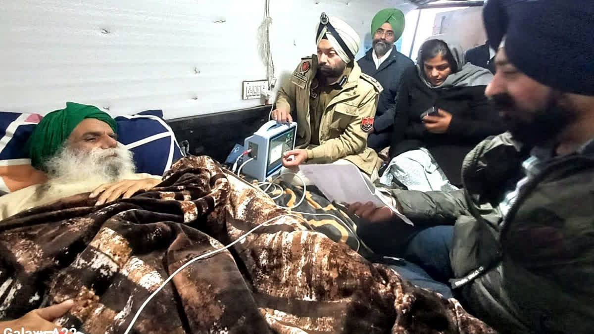 Police officials meet farmer leader Jagjit Singh Dallewal who is fasting to death and appealed to him to take care of his health, at the Khanauri border near Patiala on Friday.