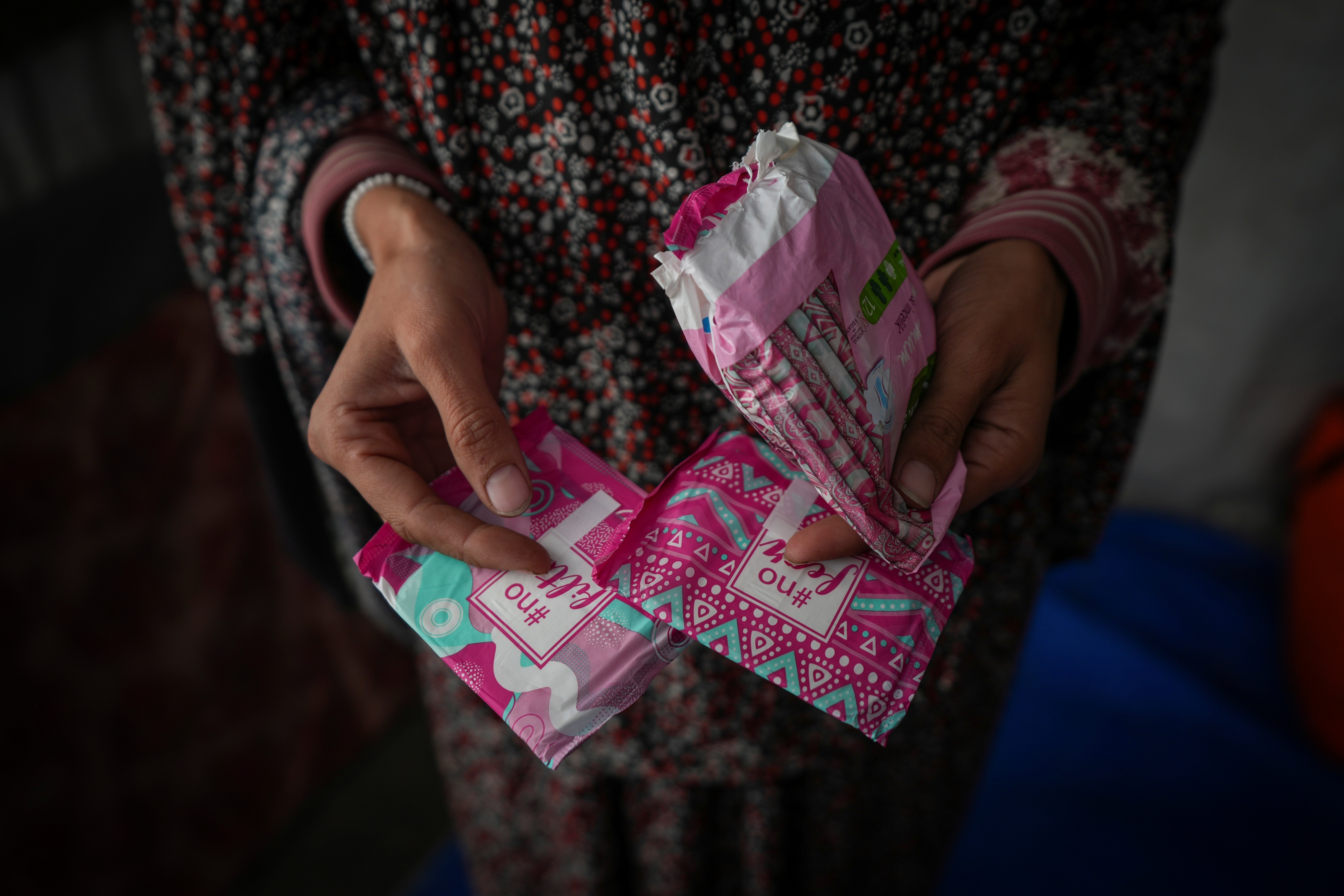 Wafaa Nasrallah shows her sanitary pads at her tent in a camp for displaced Palestinians.