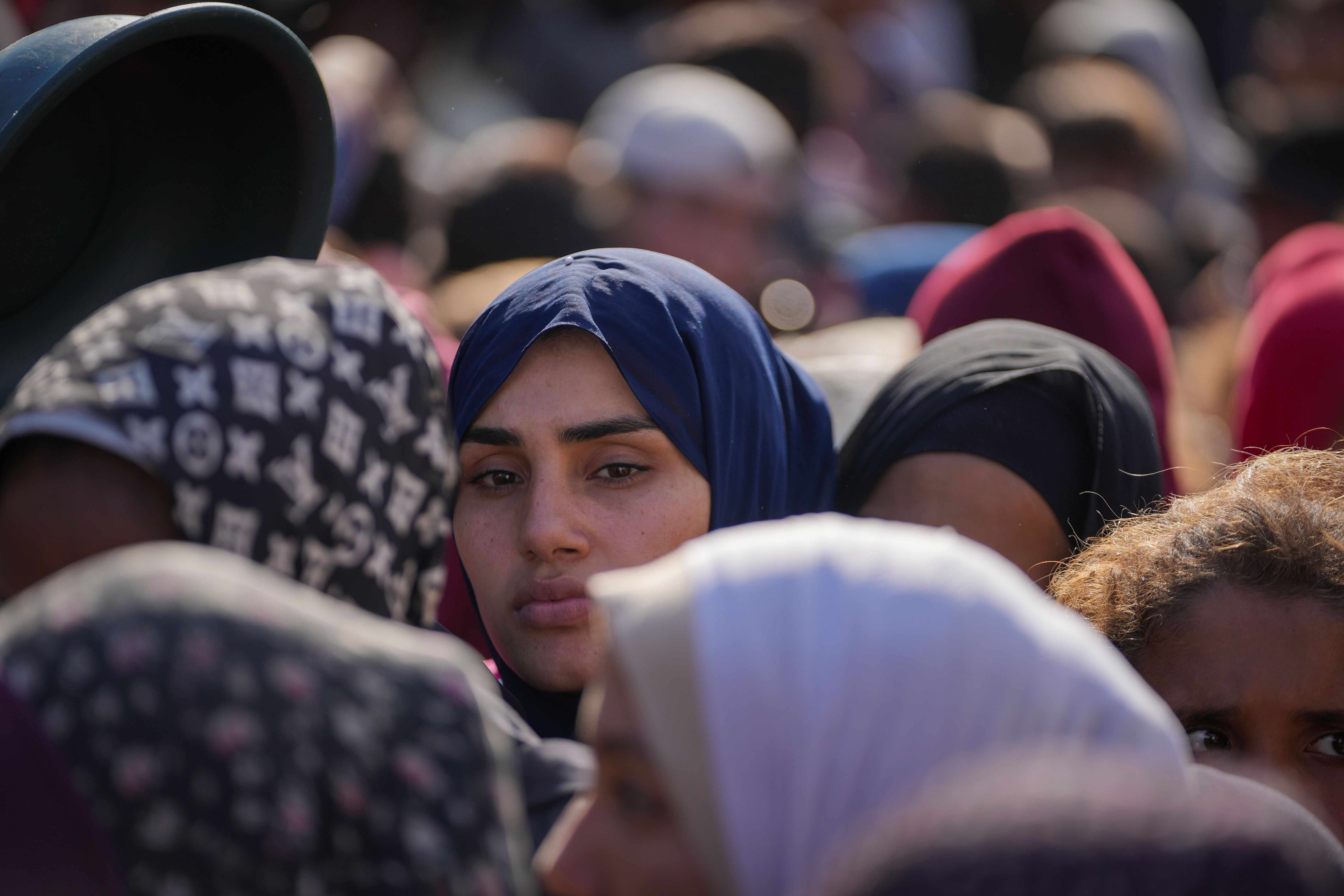 Women line up to receive donated food at a distribution center for displaced Palestinians.