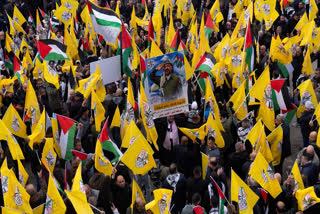 Palestinians hold yellow Fatah movement flags as they demonstrate in support of the Palestinian security forces in the Jenin refugee camp in the Israeli-occupied West Bank, Sunday, Dec. 29, 2024.