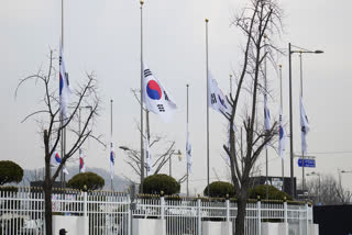 South Korean national flags fly at half-staff at a government complex in Seoul, South Korea, Monday, Dec. 30, 2024, a day after a jetliner skidded off a runway, slammed into a concrete fence and burst into flames at an airport the town of Muan.