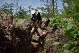 A Ukrainian serviceman carries a US Stinger air defence missile launcher in a trench on the front line in Zaporizhzhia region, Ukraine on May 28