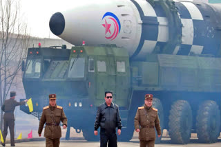 In this photo distributed by the North Korean government, North Korean leader Kim Jong Un, center, walks near what it says is a Hwasong-17 intercontinental ballistic missile (ICBM) on the launcher at an undisclosed location in North Korea on March 24, 2022.