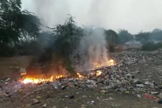 people set fire to garbage piles in railway area in jhansi