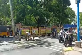 Female police removes broken egg waste that fell on the road