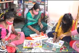 Women making rakhi