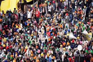 A group of agitating farmers breaks through police barricades