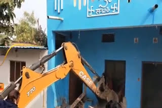 Bulldozer on illegal house