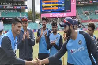 Jasprit Bumrah hands Test cap to debutant Navdeep Saini