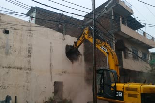 Corporation's bulldozer on illegal construction