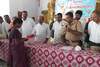 MLA Challa Dharmareddy distributing house papers