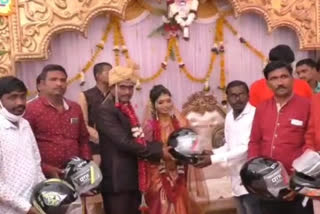 groom gifted helmets to Guests to attending marriage ceremony