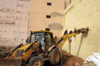 bulldozer on two illegal colonies being developed in baselwa village faridabad