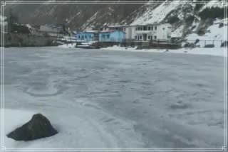 Badrinath covered with a white sheet of snow, parts of Shesh Netra lake frozen