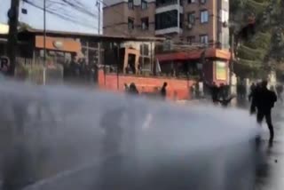 Police use water cannons to disperse protesters as they gather in the restricted zone in Nepal