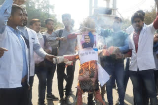 effigy of Medical Education Minister Vishwas Sarang blew