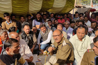 Businessmen sitting on a protest against loot