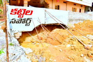 locals shocked after seeing sticks support to compound wall in kukatpally