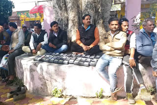 Employees of cooperative societies sitting on dharna carrying machines