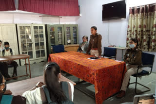 Female police officer giving information to girl students