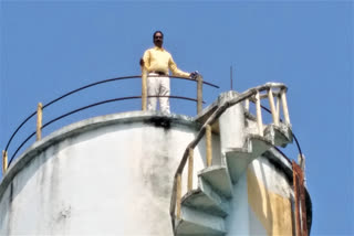 man protested on a water tank, demanding an inquiry into corruption in the gram panchayat office in mahabubabad