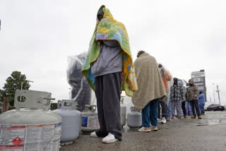 customer waits in line to fill their propane tanks