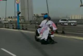 West Bengal CM Mamata Banerjee travels on an electric scooter in Kolkata as a mark of protest against rising fuel prices