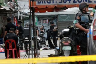 Policemen investigate the blast site in Manila