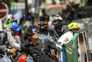 A protester prepares to throw a part of banana towards the police during a protest against the military coup in Yangon